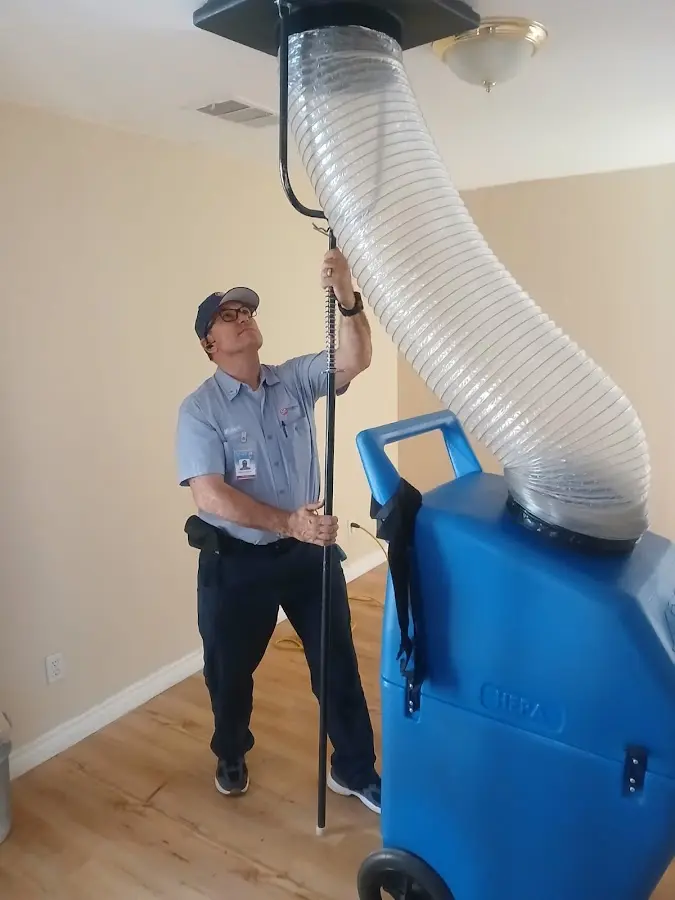 Furnace Tune-Up technician using HEPA equipment in Covington